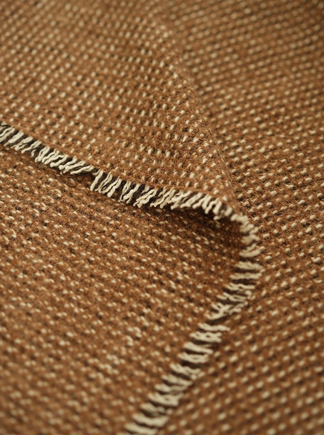 Close-up van een bruine angora wollen plaid met vouw met franjes.